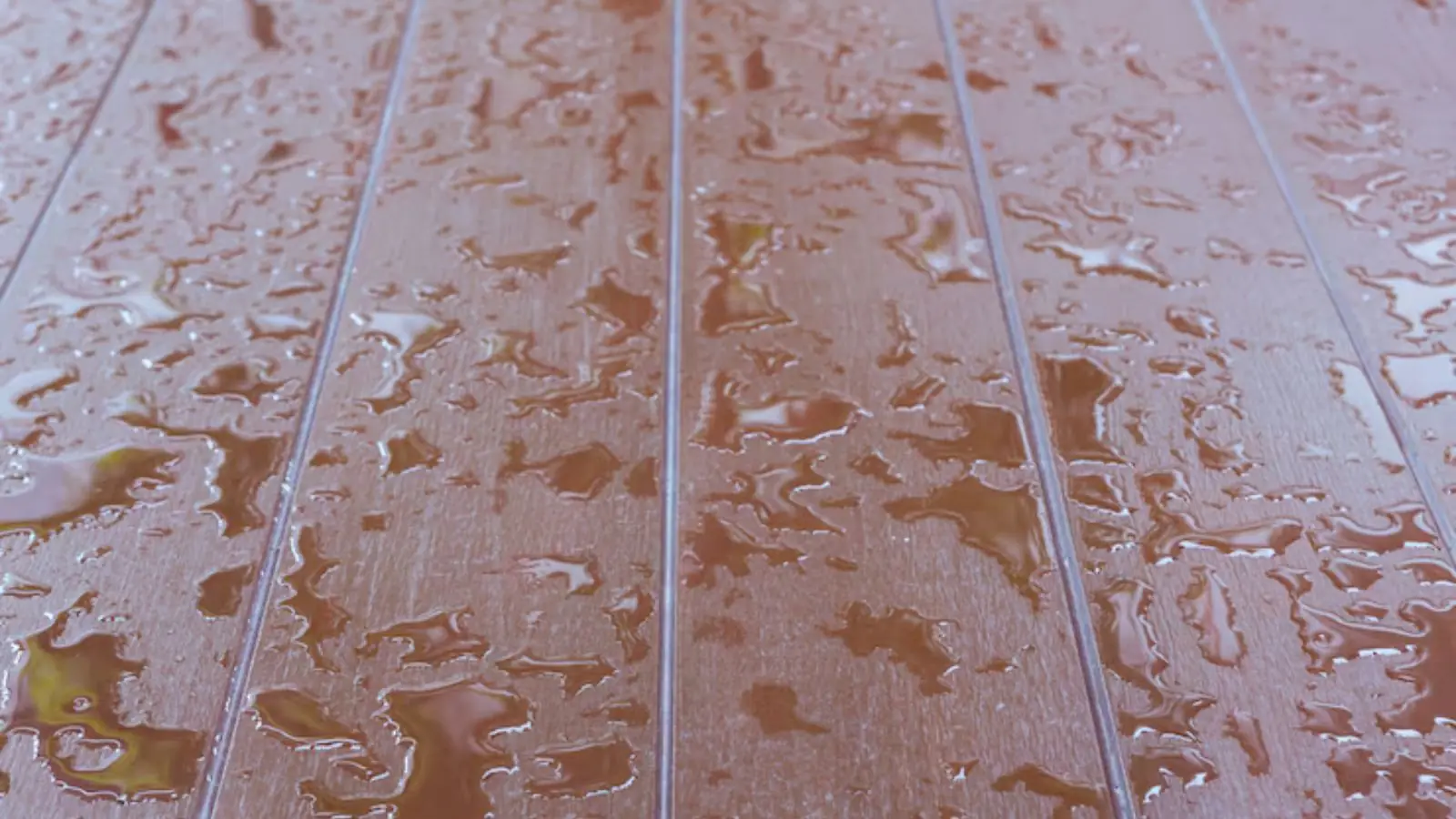 Water droplets on wet plank flooring