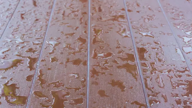 Water droplets on wet plank flooring